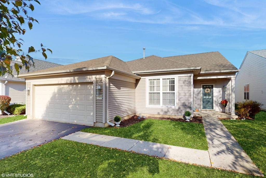 ranch-style house with a front yard and a garage