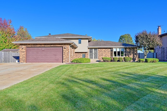 view of front of property featuring a garage and a front lawn