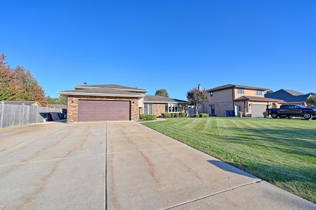 view of front of home featuring a front lawn and a garage