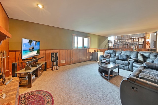 carpeted living room with wooden walls