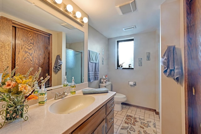 bathroom featuring vanity, toilet, tile patterned floors, and an enclosed shower