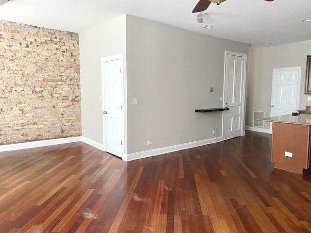 interior space with ceiling fan and dark hardwood / wood-style floors