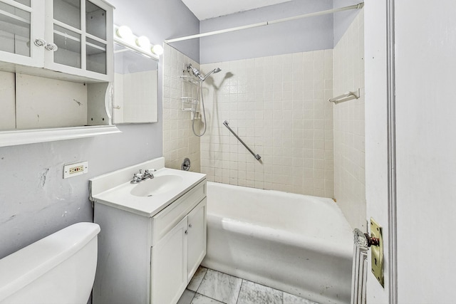 full bathroom with toilet, tiled shower / bath combo, and vanity