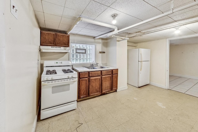 kitchen with sink and white appliances