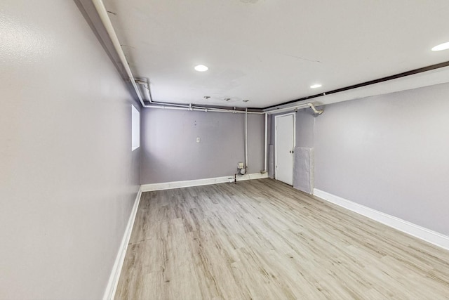 basement with light hardwood / wood-style flooring