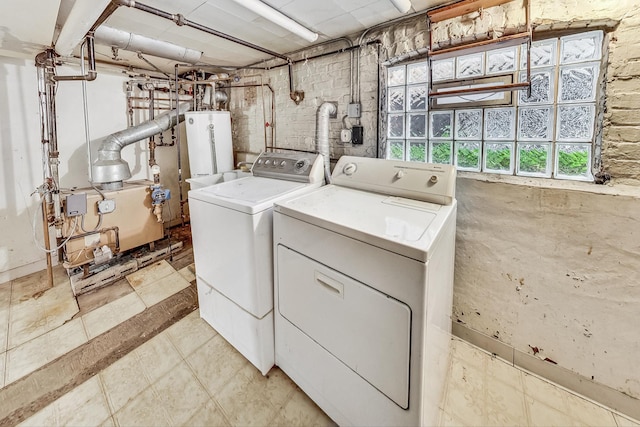 laundry area featuring water heater and washer and clothes dryer