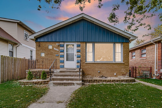 bungalow-style home featuring a yard