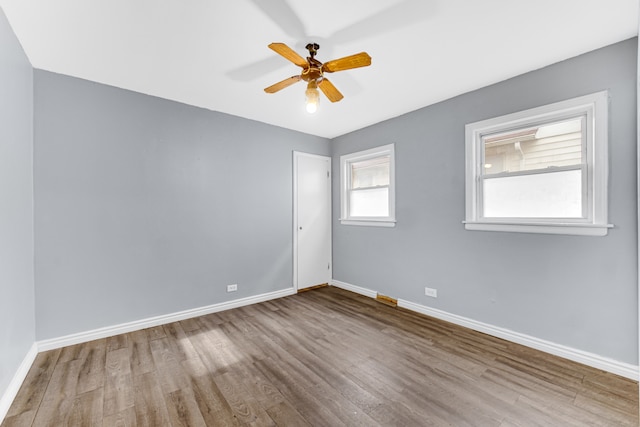 empty room with light hardwood / wood-style floors and ceiling fan