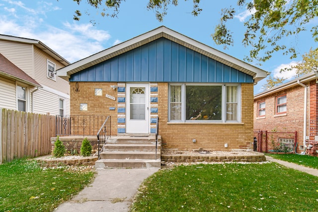 bungalow-style home featuring a front yard