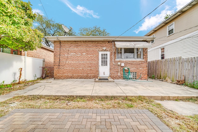 back of property with a patio