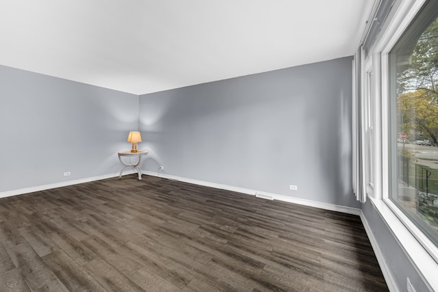 unfurnished room featuring dark wood-type flooring