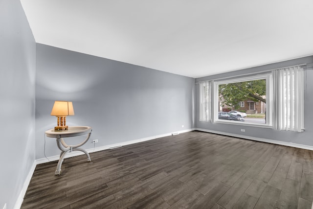 spare room with dark hardwood / wood-style flooring