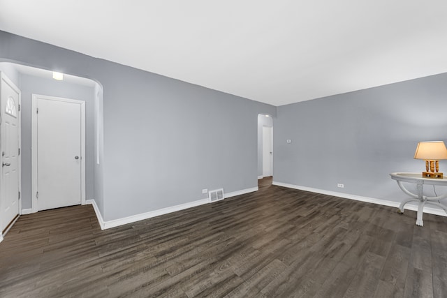 unfurnished room with dark hardwood / wood-style flooring