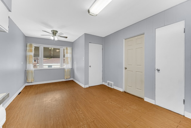 unfurnished bedroom featuring light wood-type flooring and ceiling fan