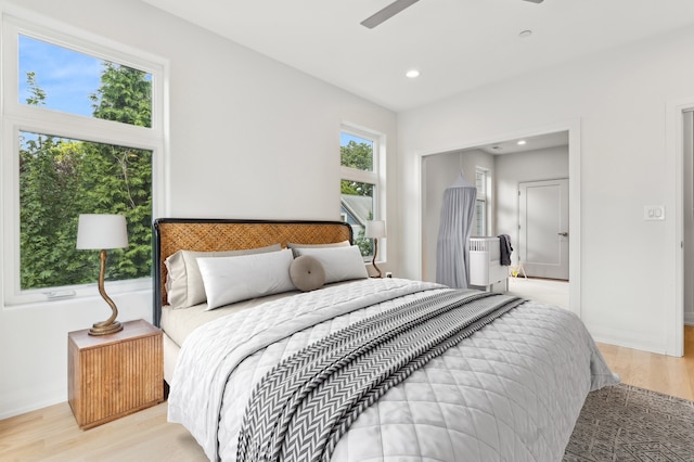 bedroom with light wood-type flooring and ceiling fan