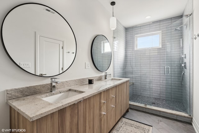 bathroom featuring vanity and a shower with shower door