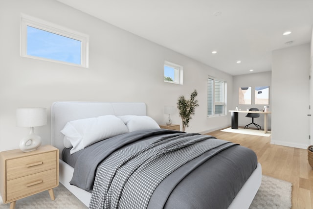 bedroom featuring light hardwood / wood-style flooring and multiple windows