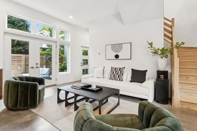 living room with french doors and a towering ceiling