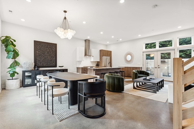 dining area with french doors and a notable chandelier