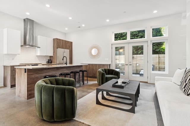 living room featuring french doors and a towering ceiling