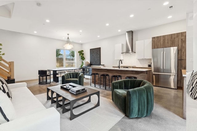 living room featuring a notable chandelier and sink