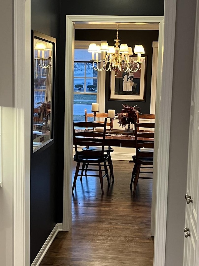 dining area featuring dark hardwood / wood-style floors and a notable chandelier