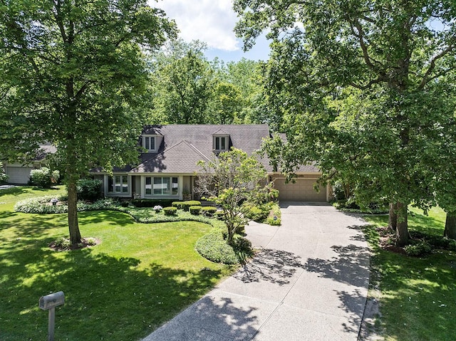 cape cod-style house with a garage, driveway, and a front lawn