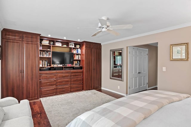 bedroom with ornamental molding, wood finished floors, a ceiling fan, and baseboards