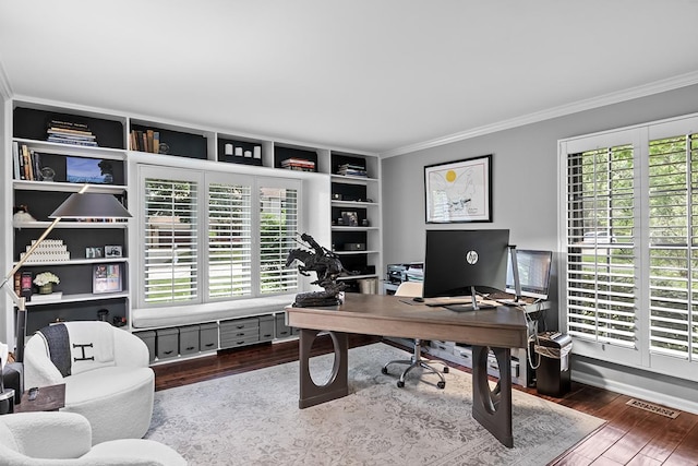 office area with baseboards, visible vents, wood finished floors, and ornamental molding