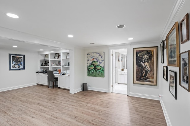 unfurnished office with light wood-style flooring and baseboards