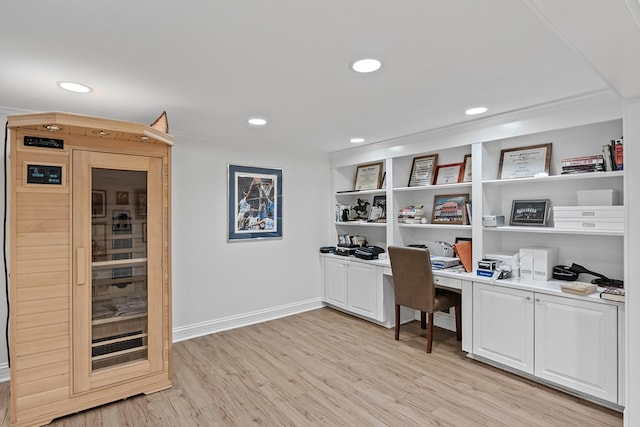 office space with recessed lighting, baseboards, a sauna, built in study area, and light wood finished floors