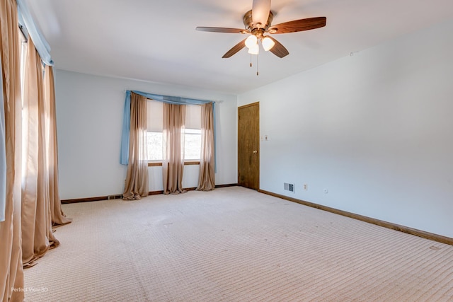 unfurnished room featuring light carpet and ceiling fan