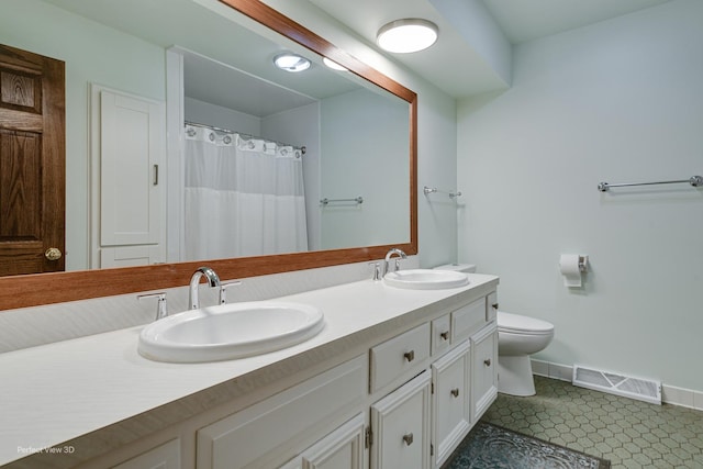 bathroom with toilet, vanity, and walk in shower