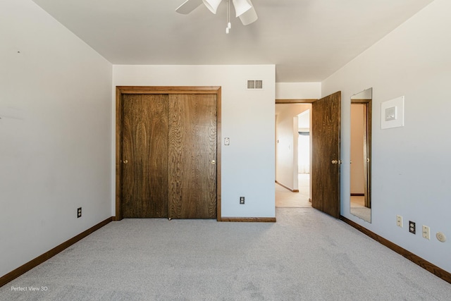 unfurnished bedroom featuring ceiling fan and light carpet