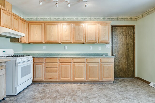 kitchen featuring light brown cabinets and white gas range oven