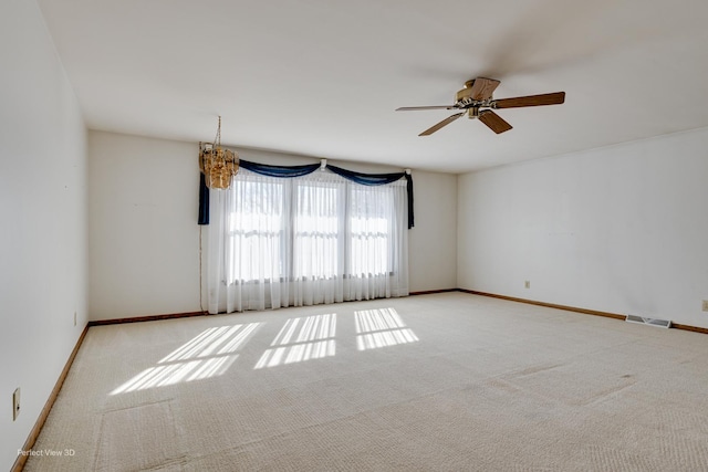 carpeted spare room with ceiling fan