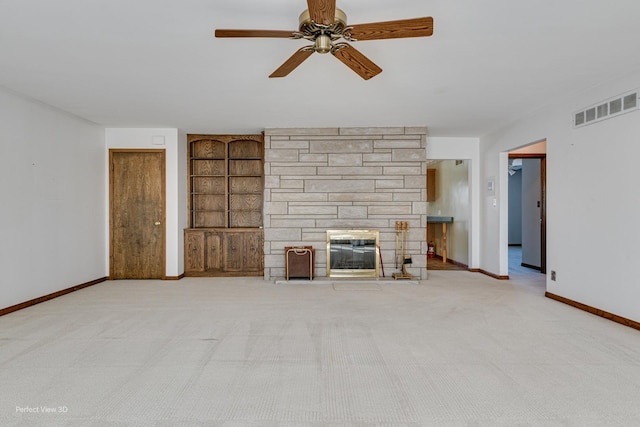 unfurnished living room with a fireplace, built in features, light colored carpet, and ceiling fan