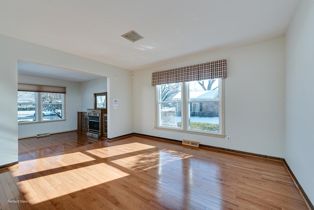 unfurnished living room featuring hardwood / wood-style flooring