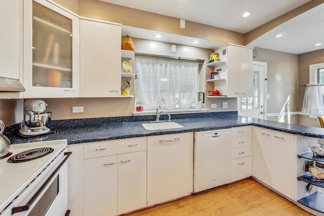 kitchen featuring white cabinets, sink, light wood-type flooring, and white appliances