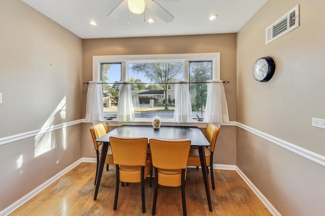 dining area with light hardwood / wood-style flooring and ceiling fan