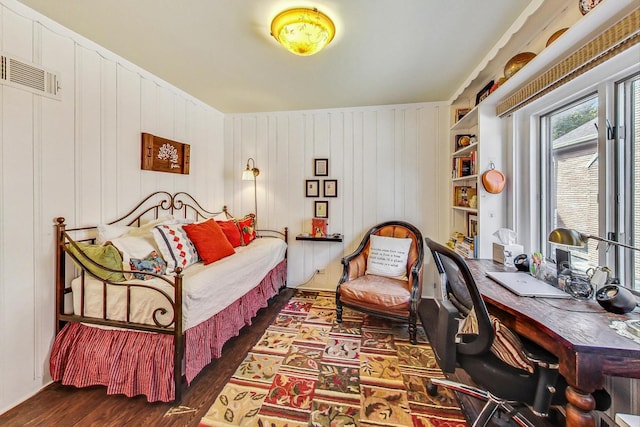 interior space featuring wood walls, dark hardwood / wood-style floors, and built in shelves