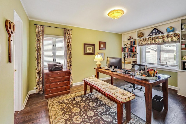 home office with ornamental molding and dark hardwood / wood-style flooring