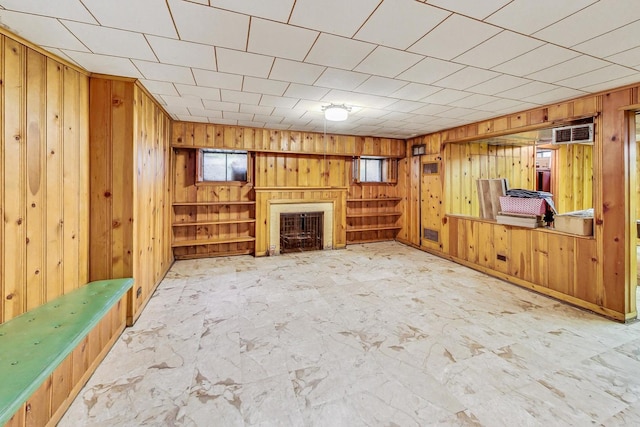 unfurnished living room with wooden walls