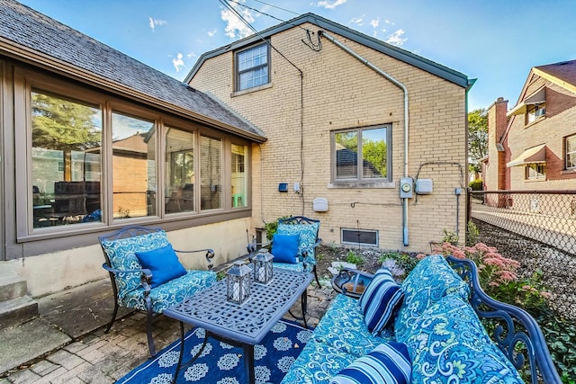 back of property featuring an outdoor hangout area and a patio