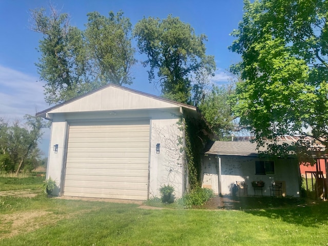 garage featuring a lawn