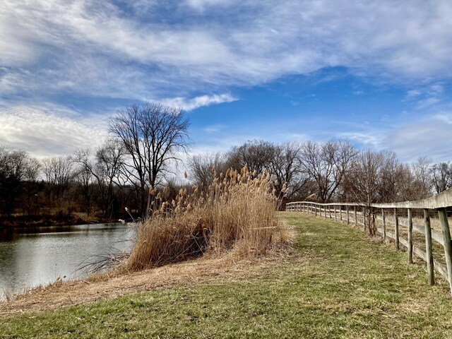 view of yard featuring a rural view and a water view