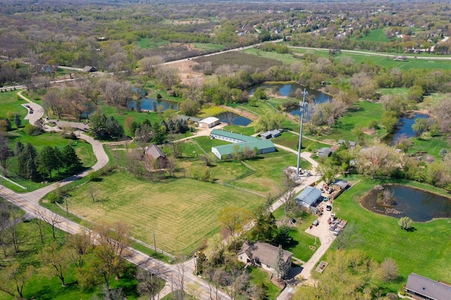 birds eye view of property featuring a water view and a rural view