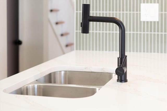 interior details with light countertops and a sink