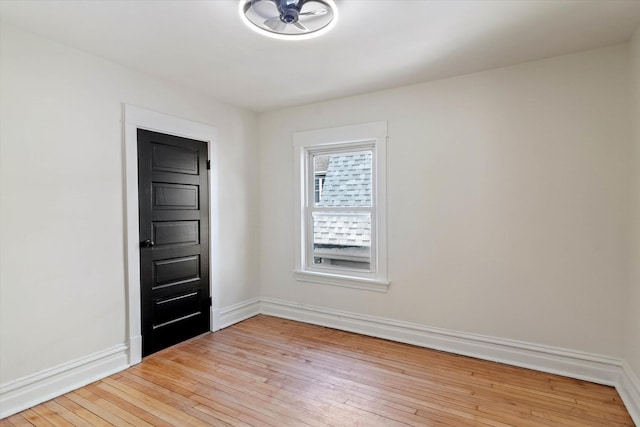 spare room with light wood-style flooring and baseboards