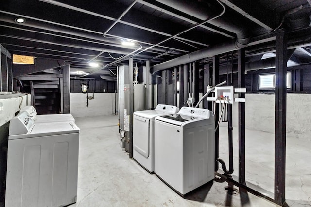 basement with washing machine and dryer and water heater